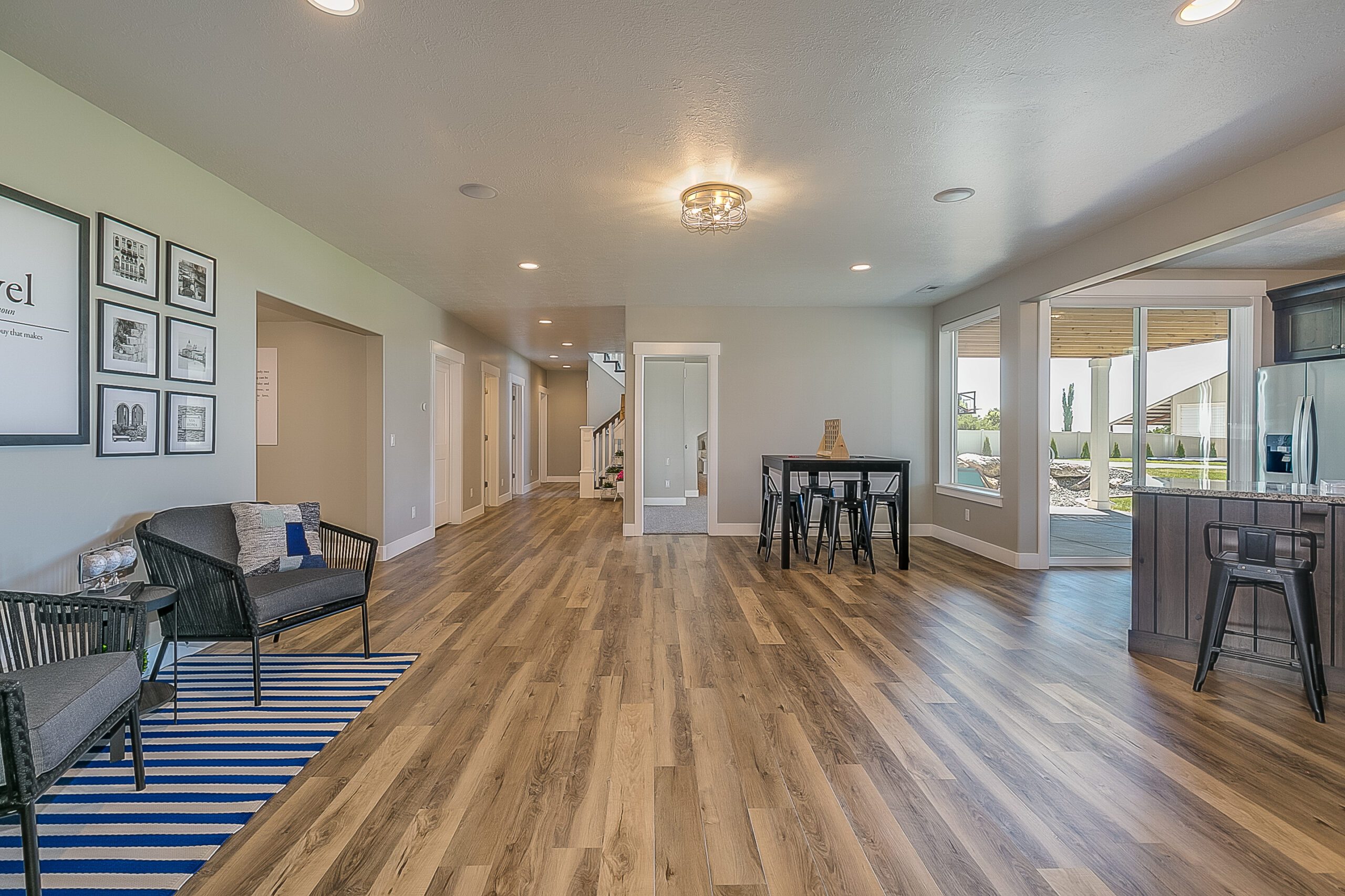 Open space in basement connected to kitchen, exercise room and theatre room